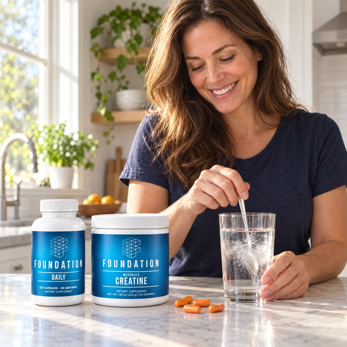 A woman stirring Foundation Creatine into a glass of water next to Foundation Daily